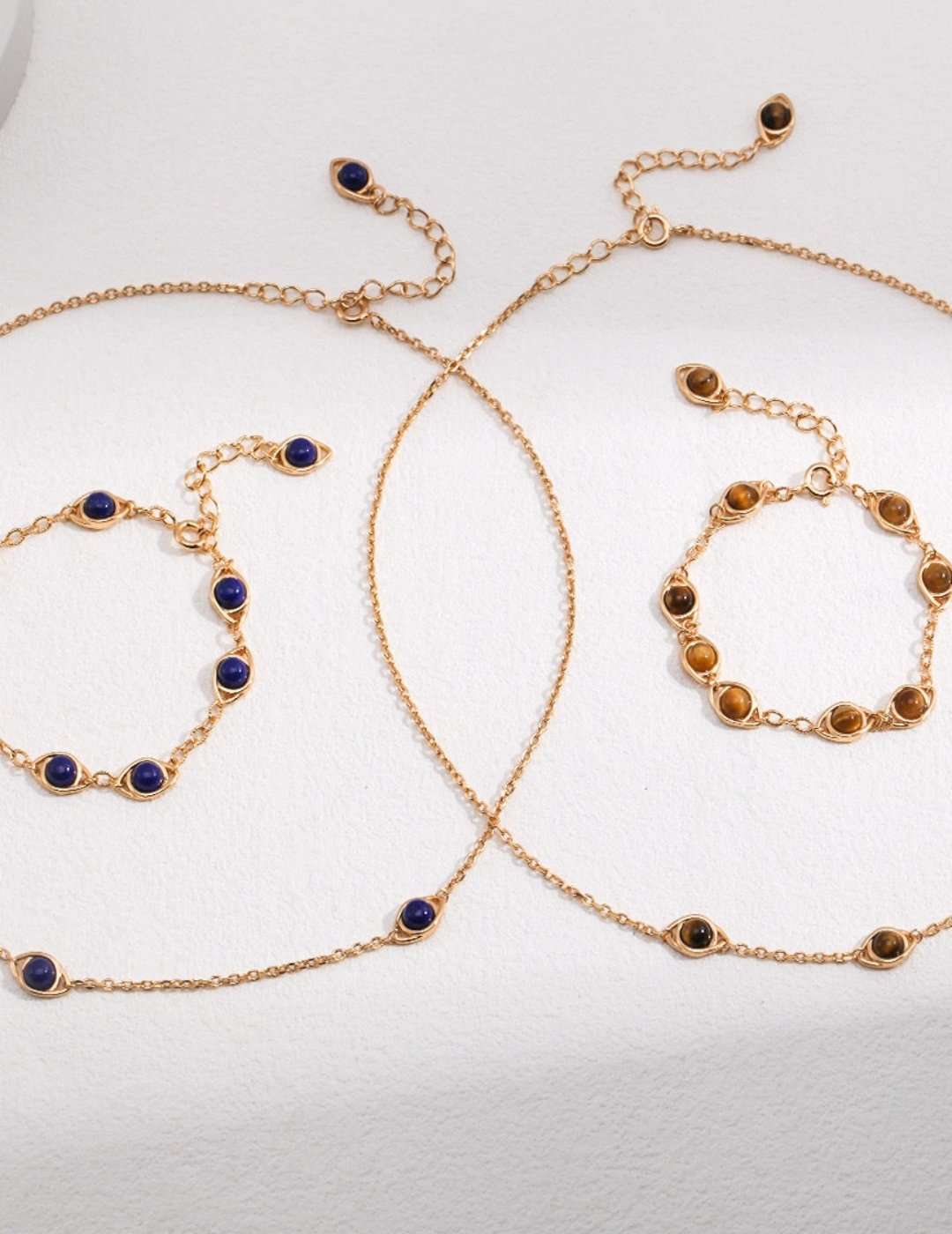Tiger eye and lapis lazuli necklaces and bracelets in gold-tone settings