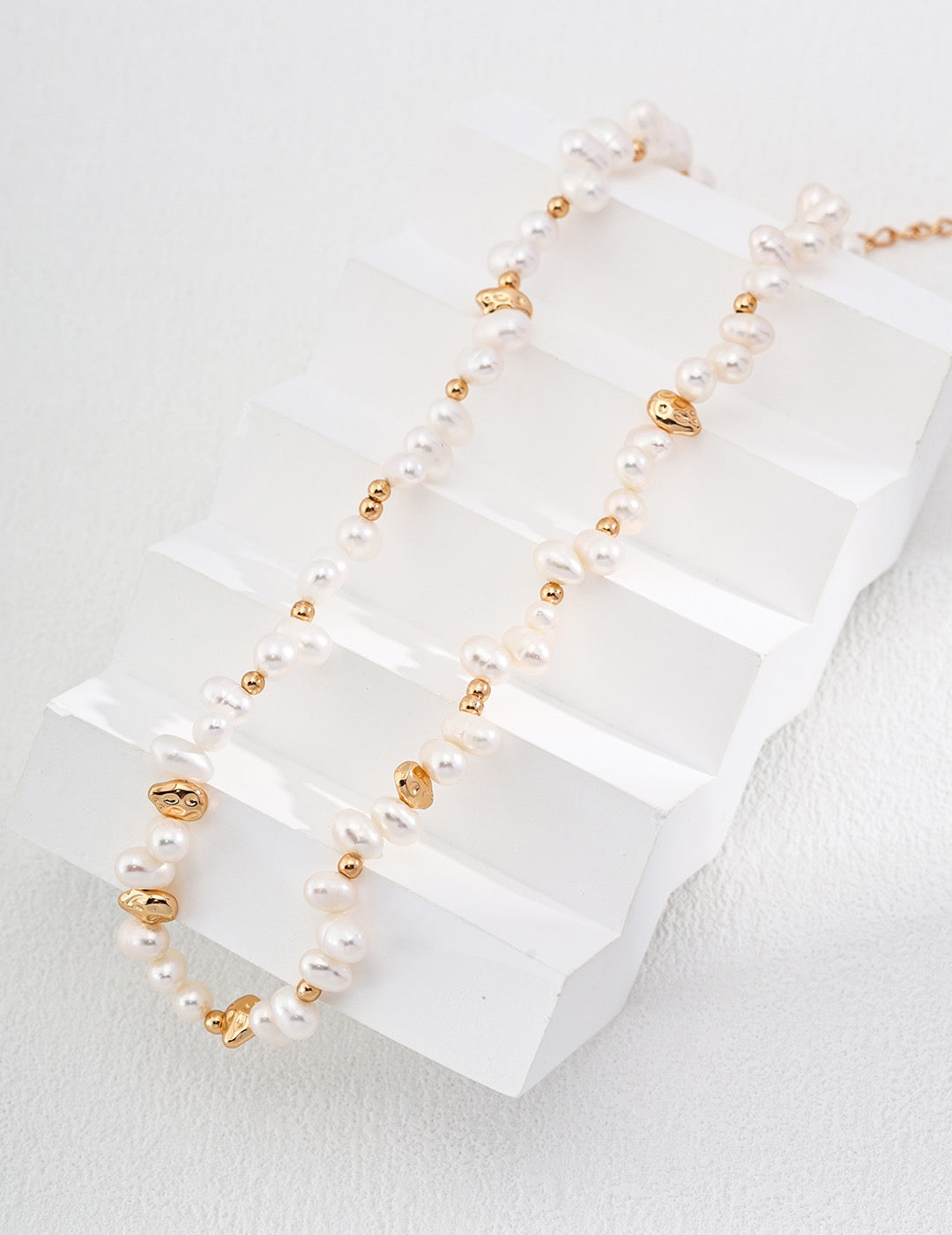 Freshwater pearl jewelry arranged on a white display by Janique Jewelry