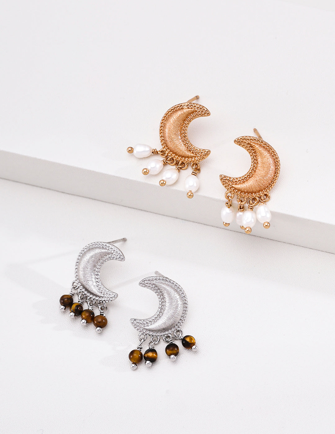 Vintage gold pearl and silver grey tiger’s eye crescent moon earrings displayed together