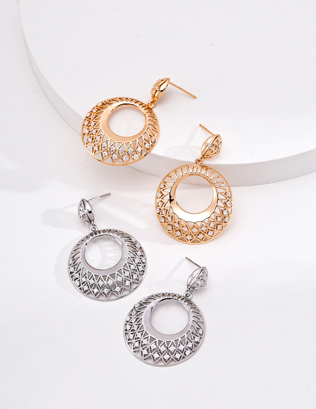Vintage gold and silver filigree circle drop earrings with openwork lattice detailing and cubic zirconia