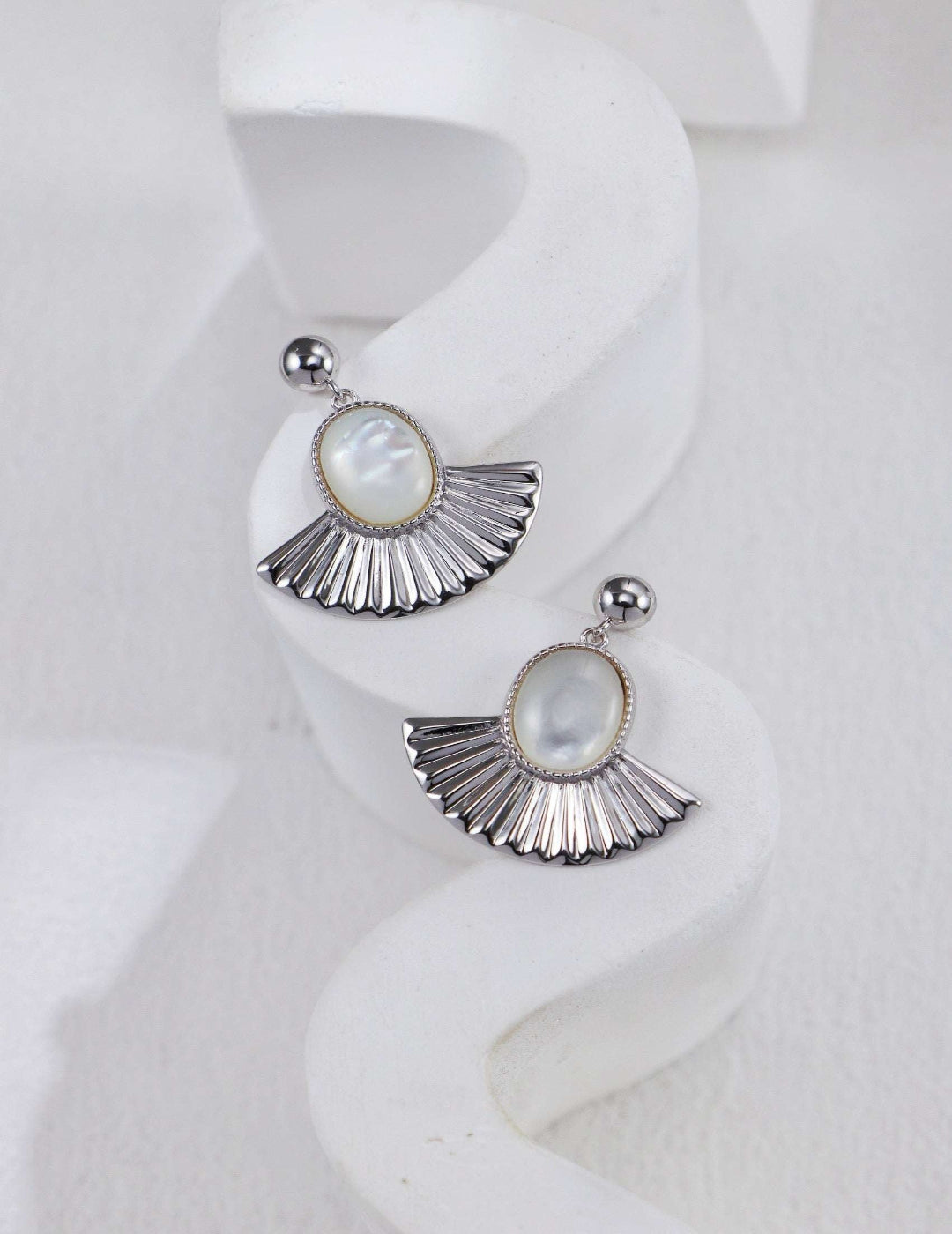 Close-up of silver mother-of-pearl earrings