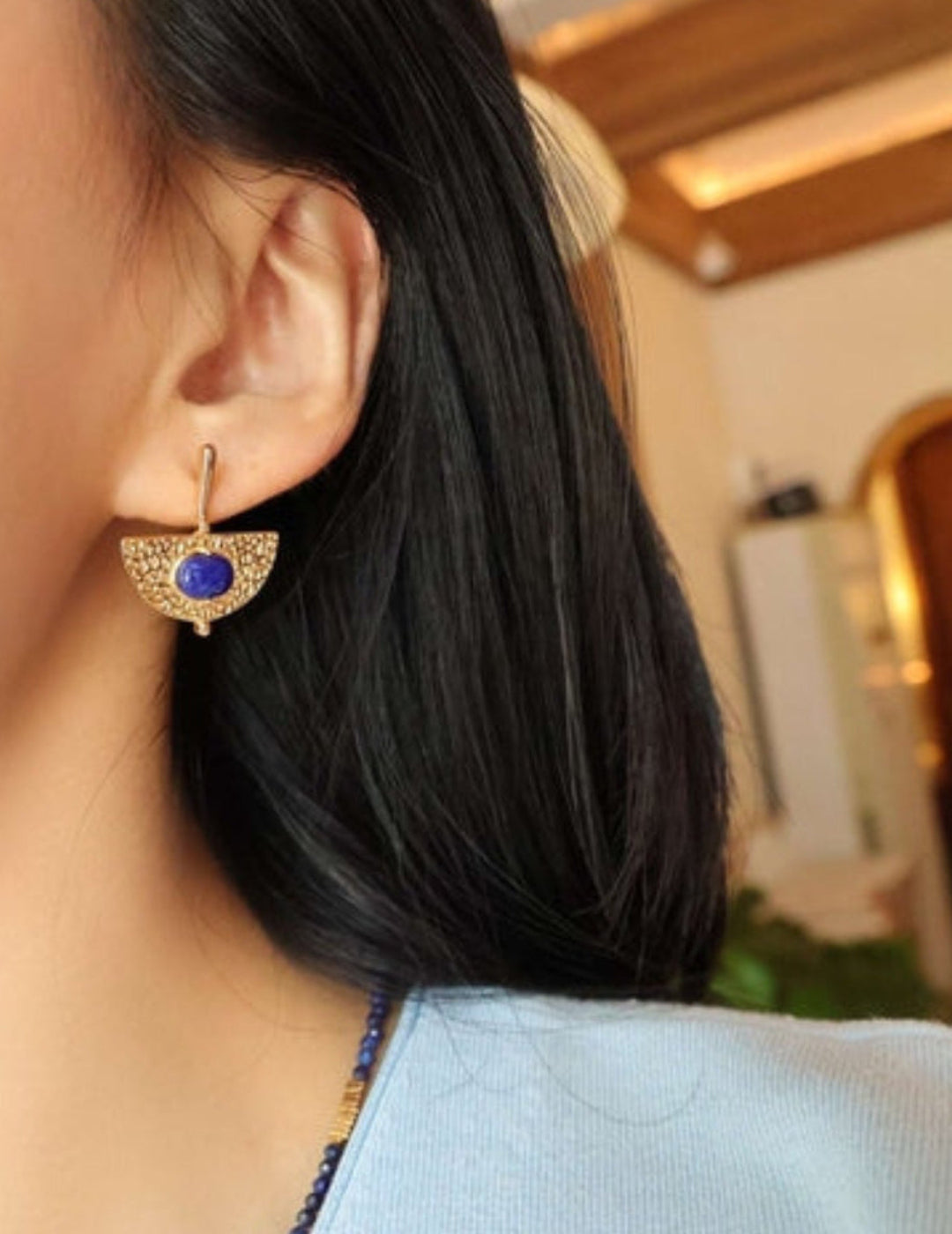 Model wearing gold Lapis Lazuli fan earrings