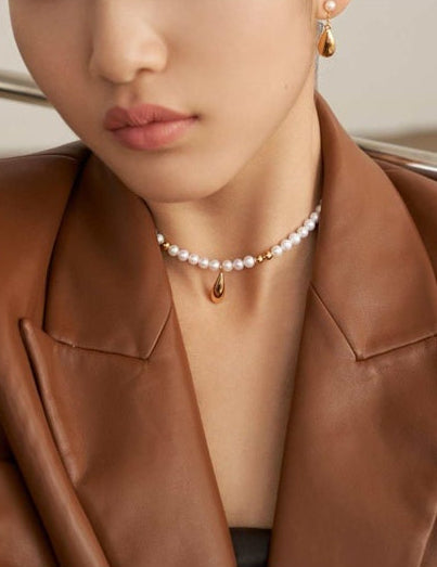 Natural pearl and gold bead necklace styled with blazer