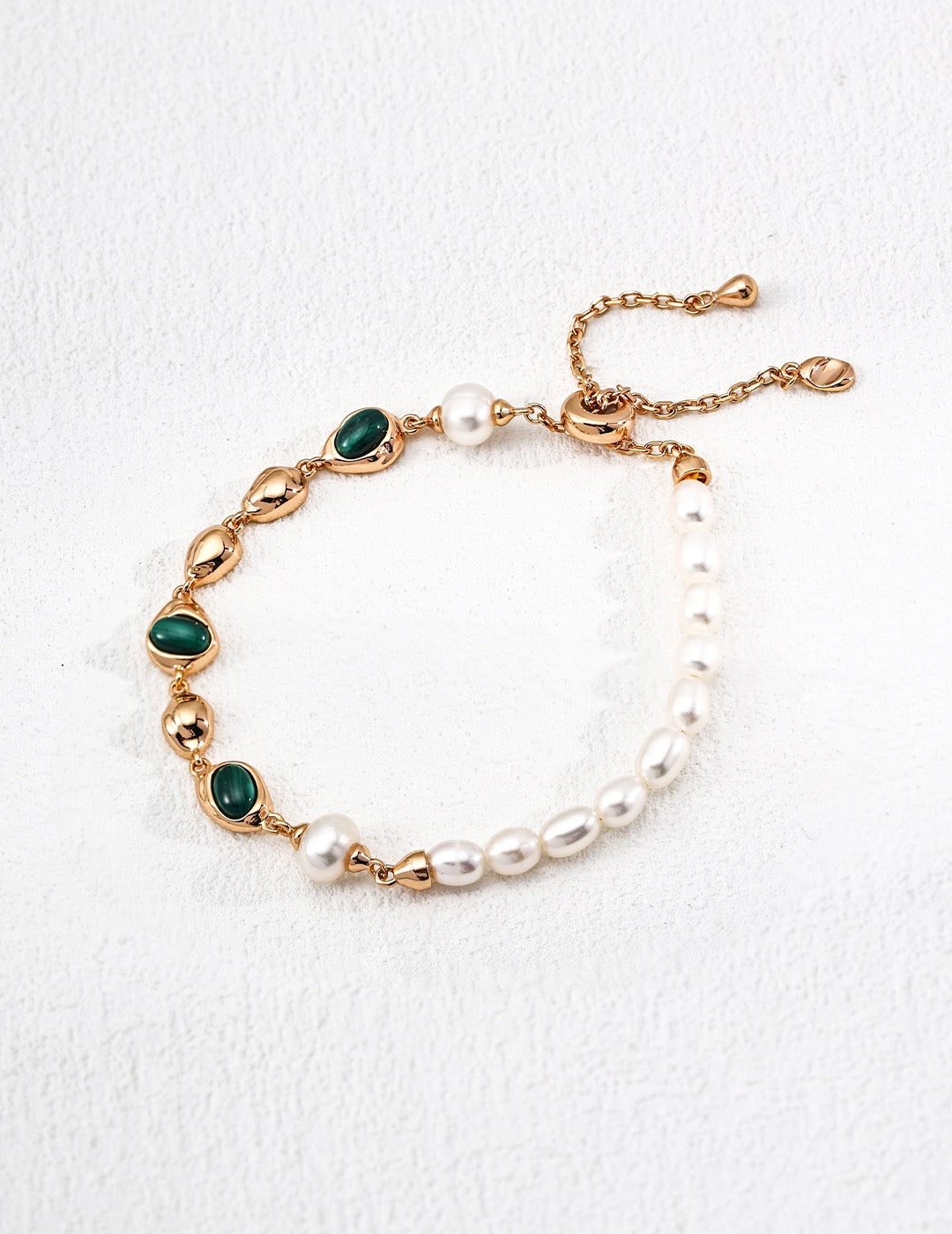 Malachite and pearl bracelet showing green oval stones and an adjustable sliding clasp