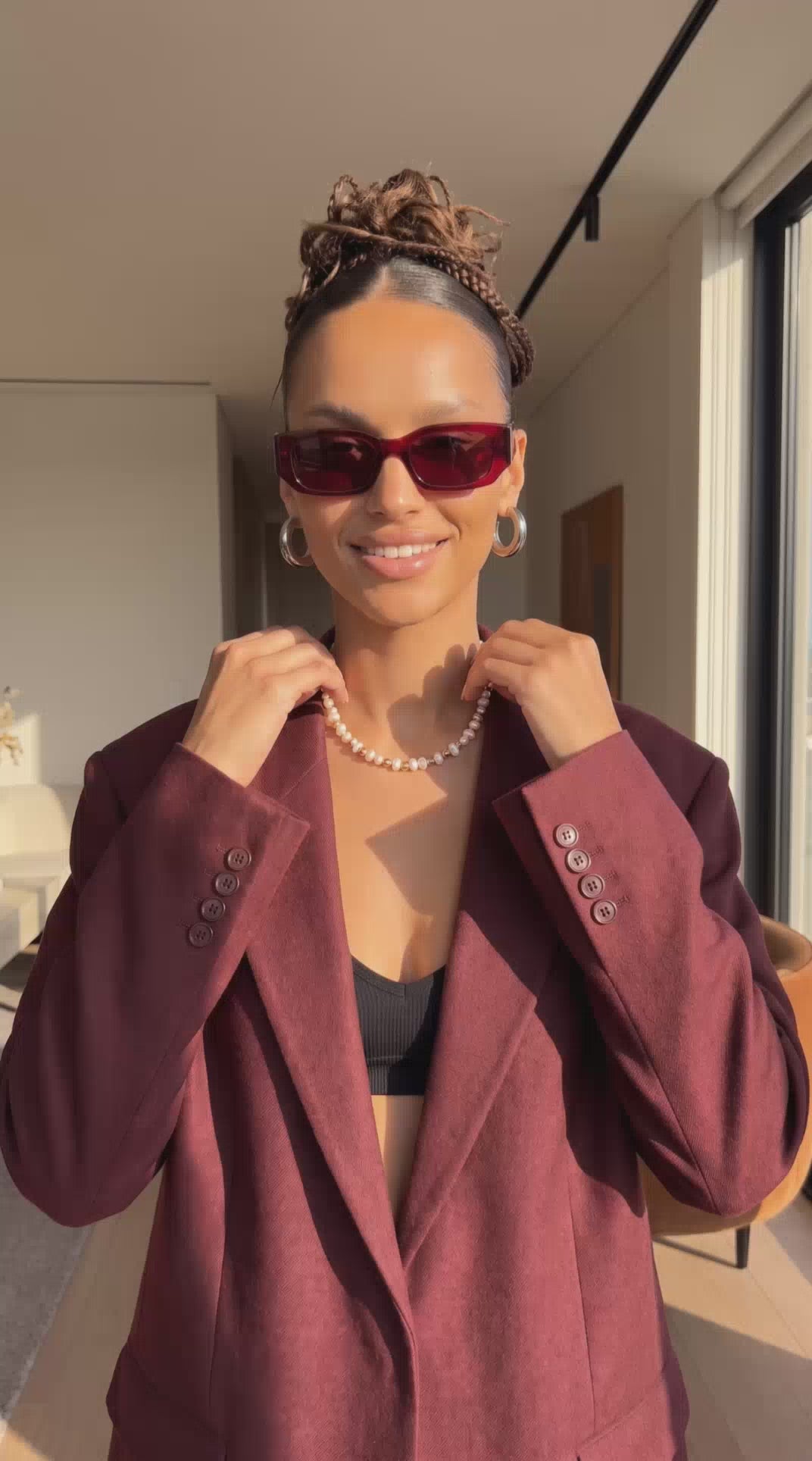 Model styling pearl necklace and hoop earrings